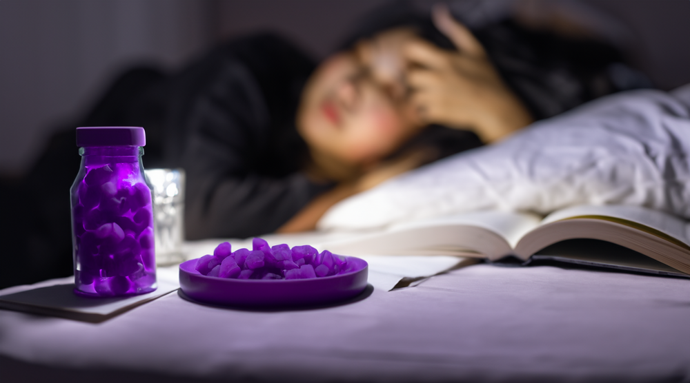  A peaceful night scene, with a person winding down for bed, reading a book, and with a bottle of light purple Ashwagandha gummy bears on the nightstand, signifying improved sleep quality and stress reduction before bed.