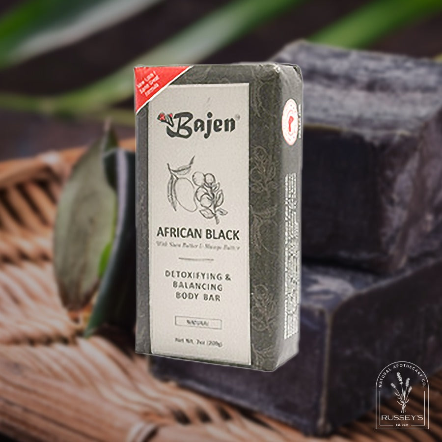 Bajen African Black soap bar with packaging on a textured surface