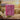 Bar of Bela soap on a wooden surface with jasmine flowers and a natural evening background.