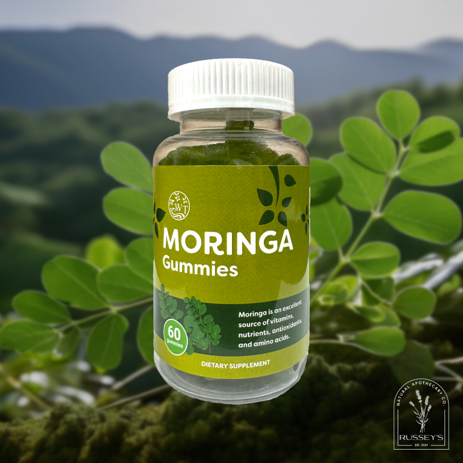 Overlay of bottle of 60 moringa gummies by The Water Tree Superfoods on moringa plant in natural environment